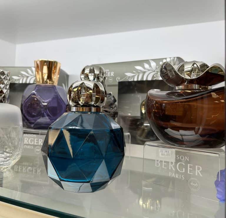 A display of perfume bottles on a glass shelf.