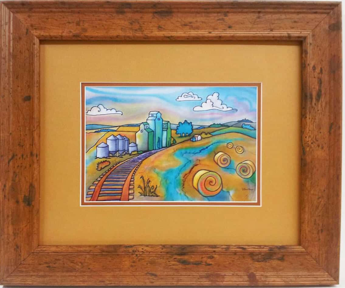 A wooden frame with a painting of a train tracks alberta