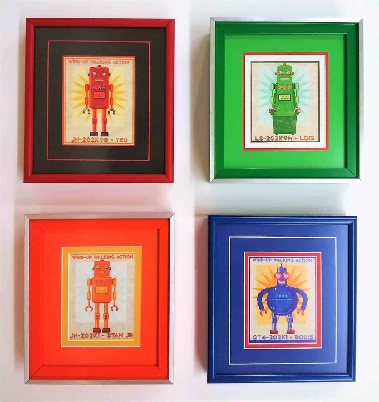 Four framed prints of robots in different colors.
