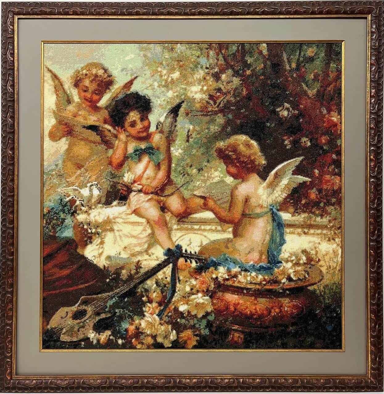 A framed cross-stitch of angels in a garden.