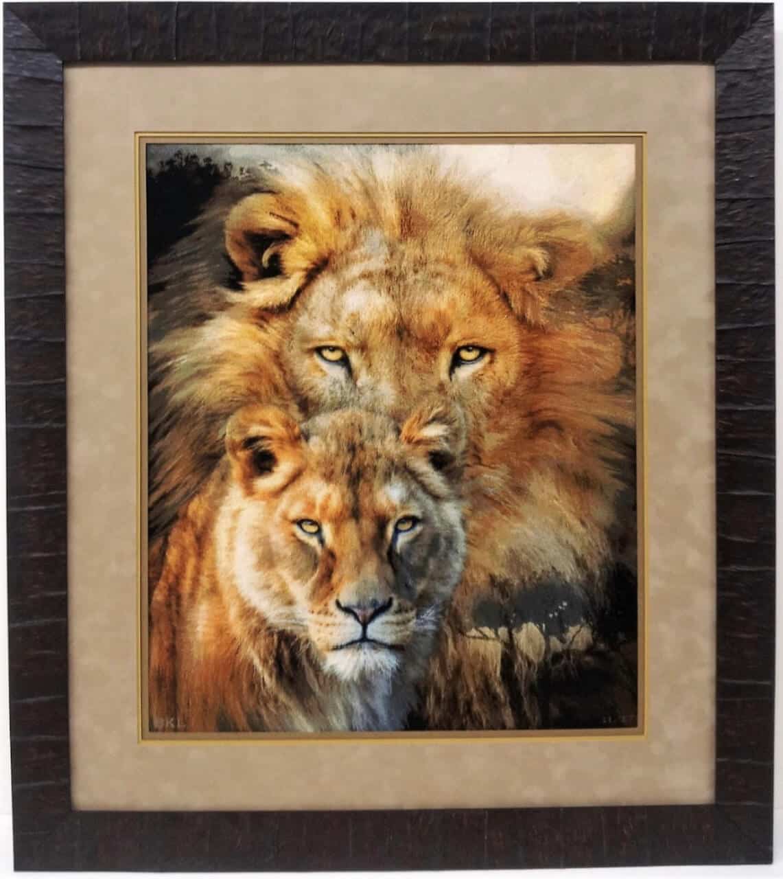 A lion and a lioness framed in a brown frame.