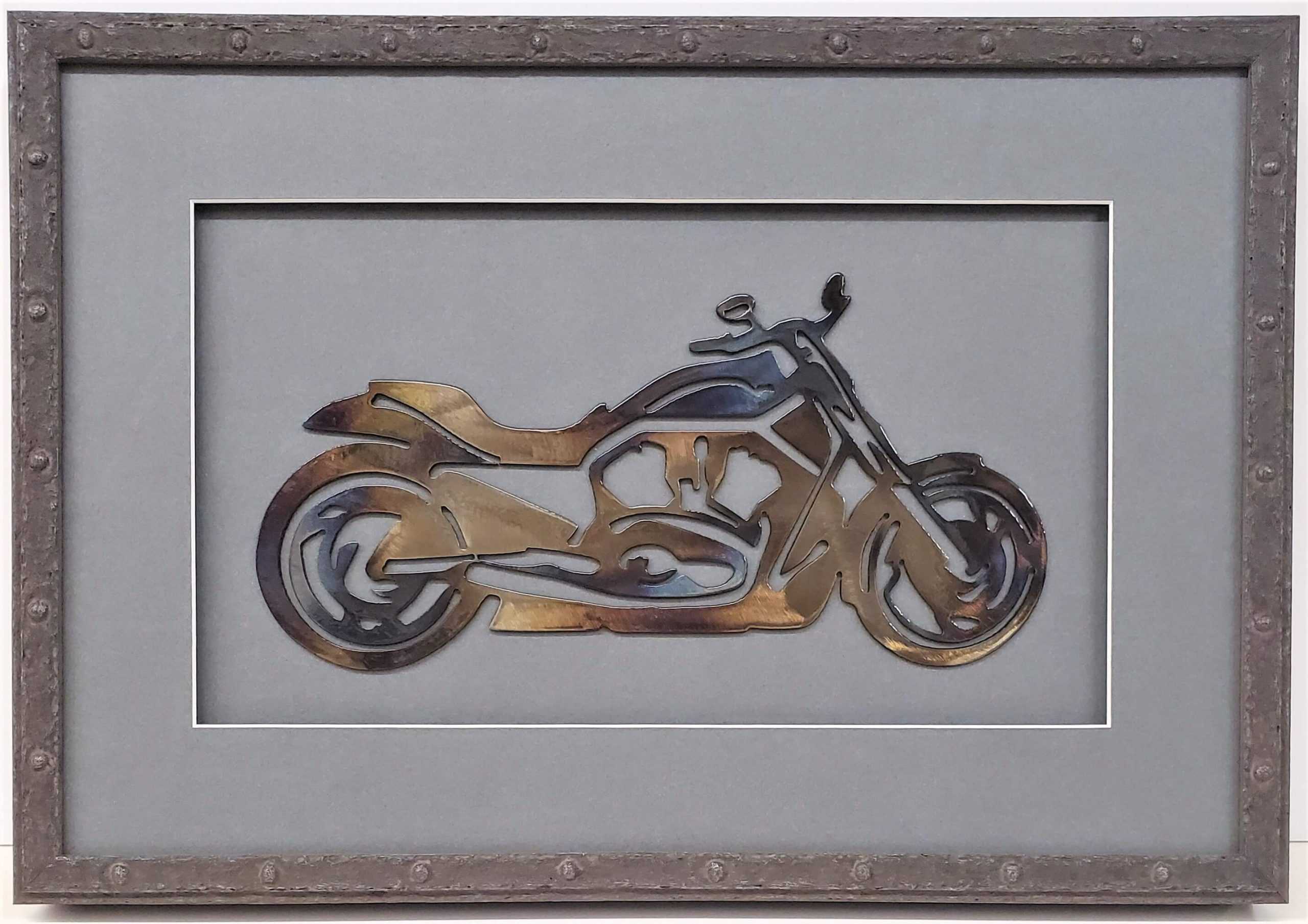 A metal motorcycle is framed in a gray frame.