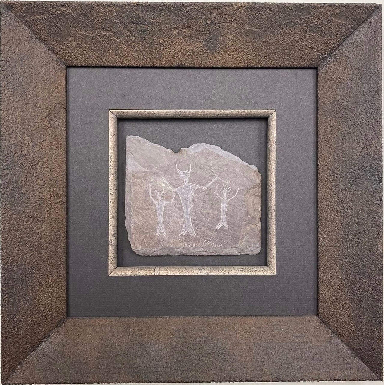 A stone framed in a brown frame.