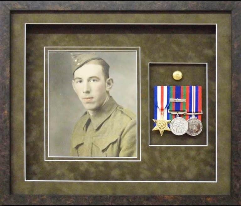 A frame with medals and a photo of a soldier.