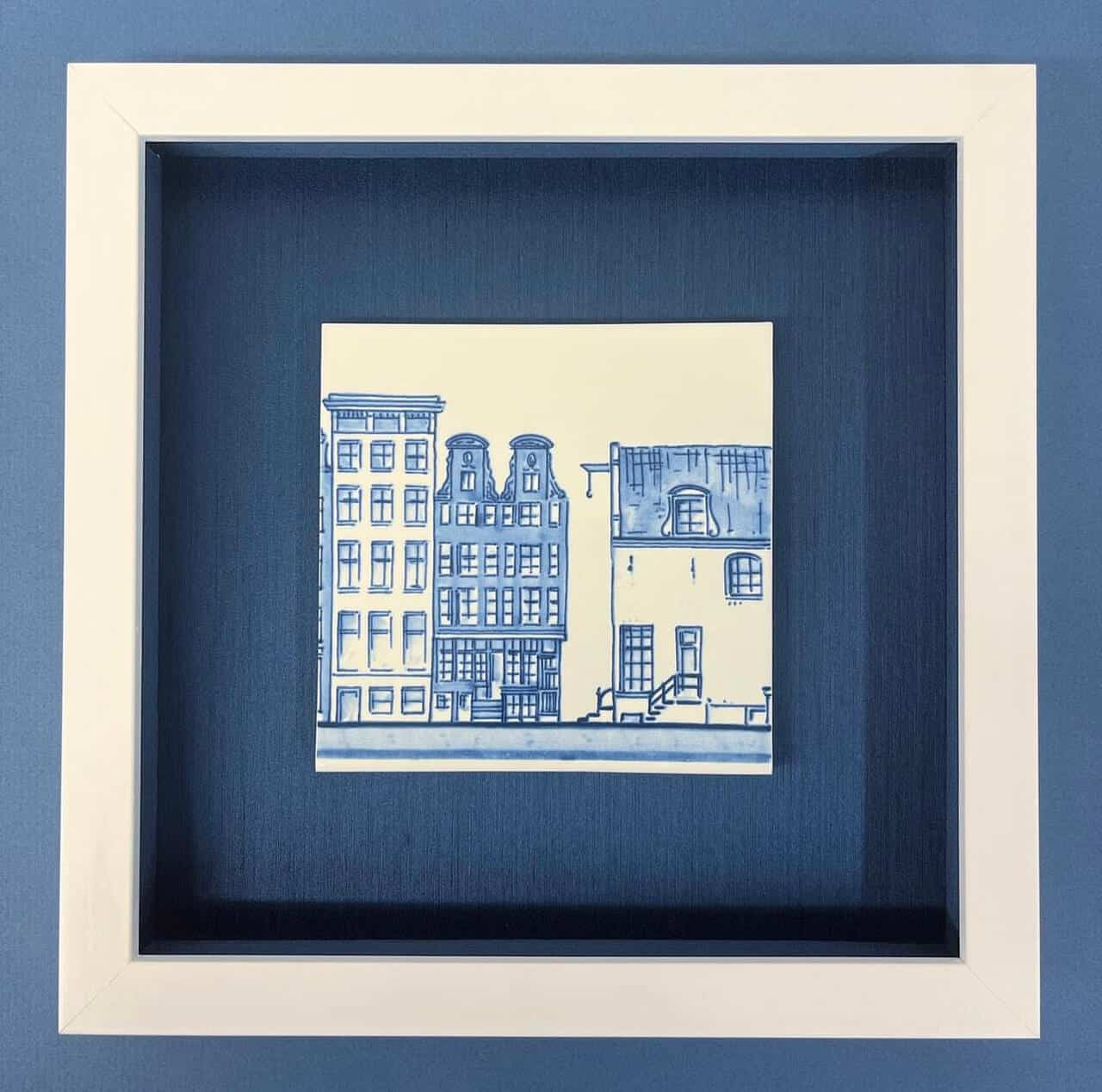 A white frame with a blue drawing of a building.