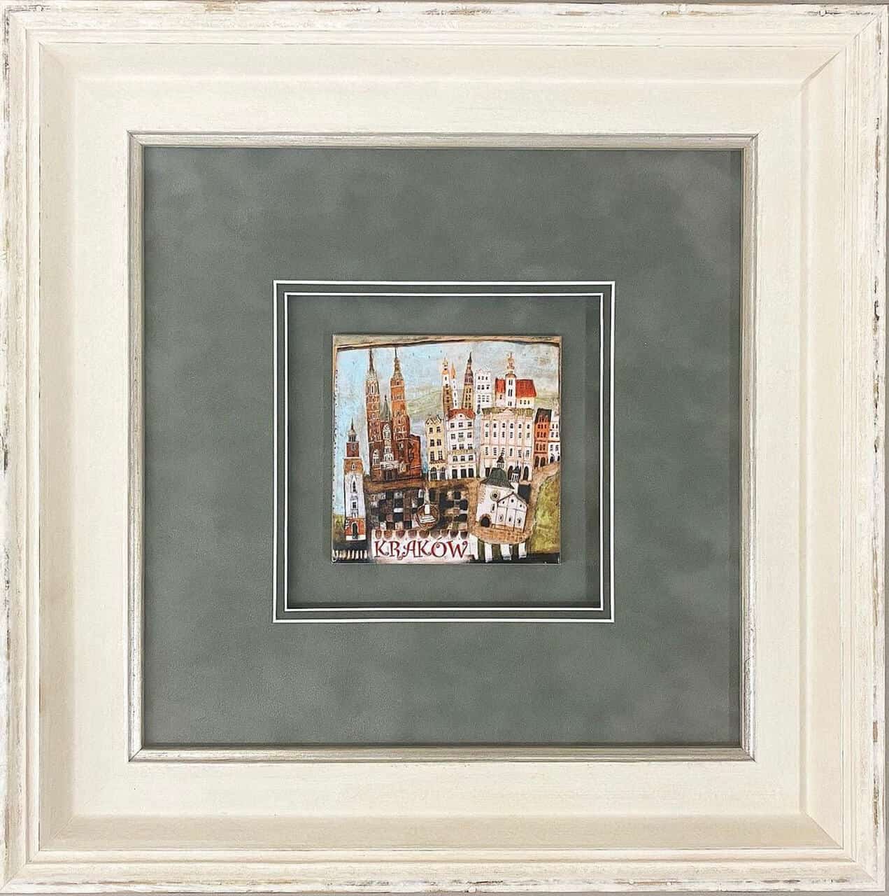 A framed picture of a city in a white frame