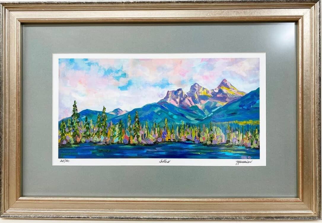 A framed painting of mountains and trees.