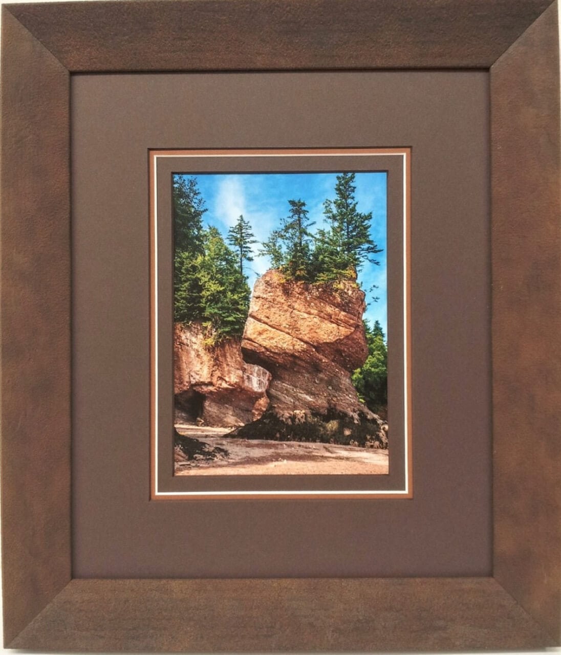 A photo of a rock formation framed in a brown frame.